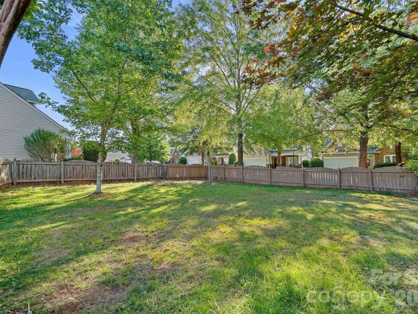 6902 Saranac Lane, Matthews, NC 28105.  MLS# CAR4368511, YatesRealty ID 24299. Private Backyard Oasis