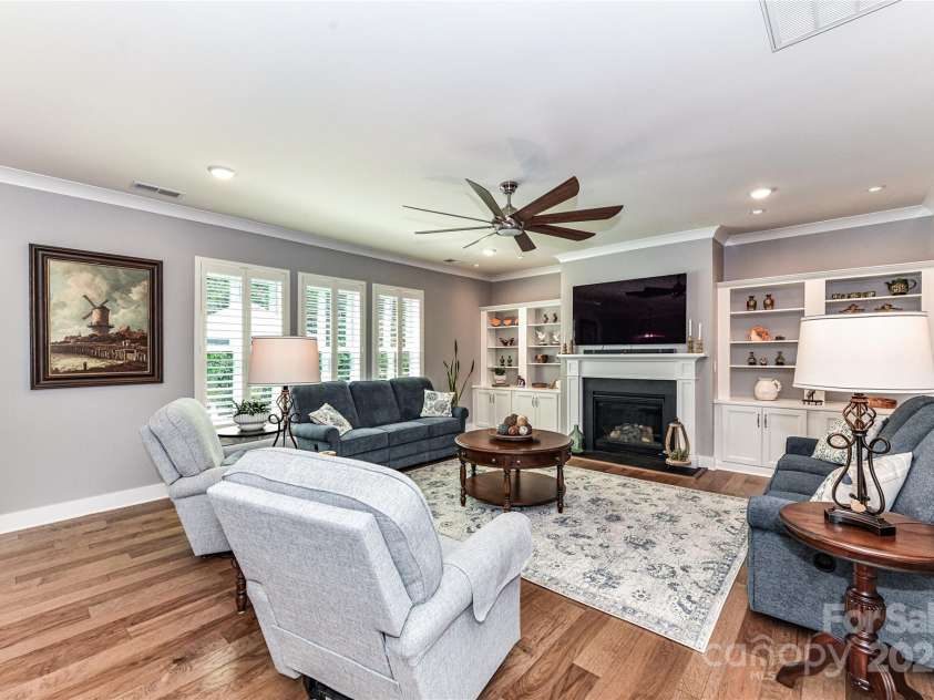 5129 Devonshire Road, Denver, NC 28037.  MLS# CAR4275511, YatesRealty ID 24318. Great Room features gas fireplace, custom built in shelving/cabinets, crown molding, designer ceiling fan, recessed lights, plantation shutters & hardwood floors!
