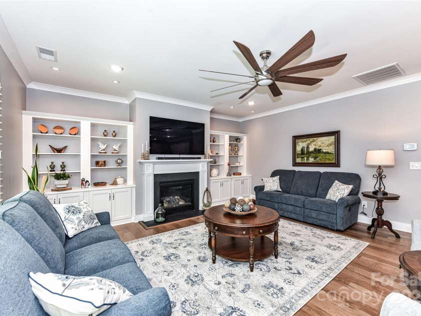 5129 Devonshire Road, Denver, NC 28037.  MLS# CAR4275511, YatesRealty ID 24318. Great Room features gas fireplace, custom built in shelving/cabinets, crown molding, designer ceiling fan, recessed lights, plantation shutters & hardwood floors!