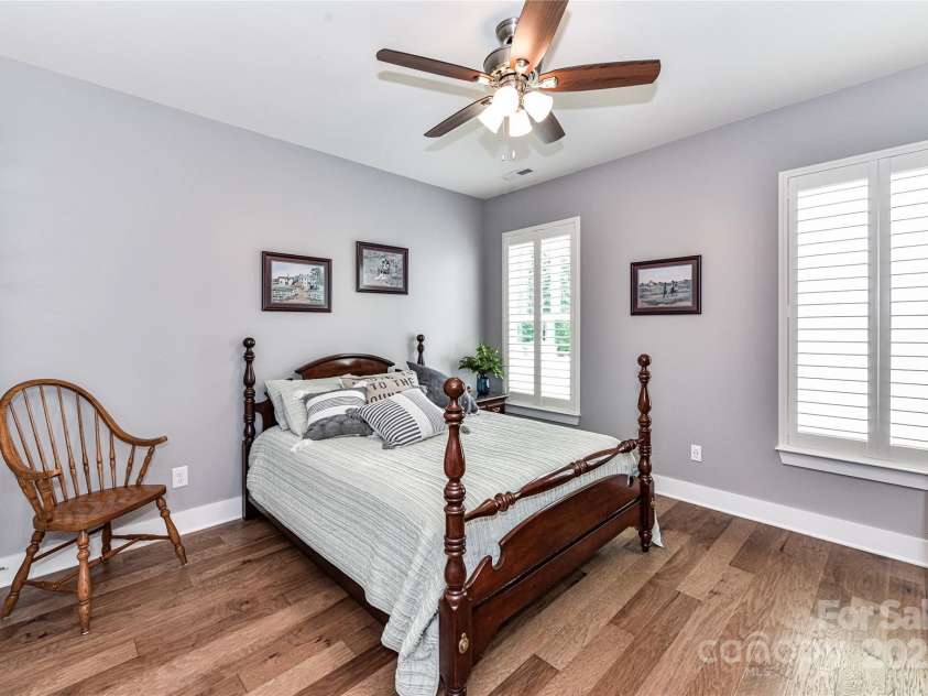 5129 Devonshire Road, Denver, NC 28037.  MLS# CAR4275511, YatesRealty ID 24318. Spacious Bedroom 2 on main level with ceiling fan/light, hardwood floors, plantation shutters, walk in closet & Jack & Jill Bath!