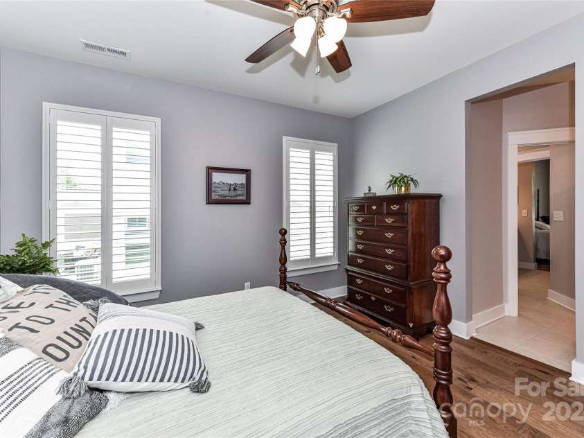 5129 Devonshire Road, Denver, NC 28037.  MLS# CAR4275511, YatesRealty ID 24318. Spacious Bedroom 2 on main level with ceiling fan/light, hardwood floors, plantation shutters, walk in closet & Jack & Jill Bath!