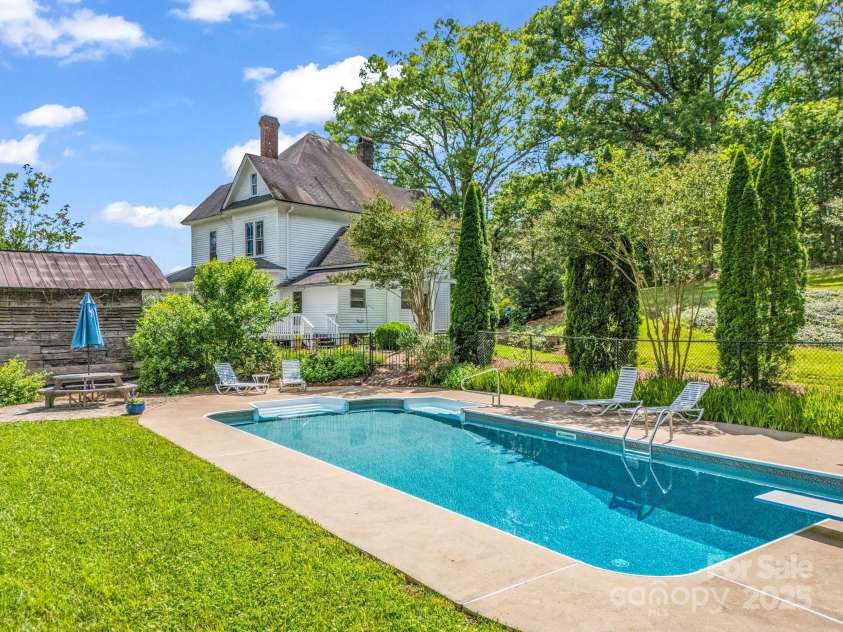 1111 Bills Creek Road, Lake Lure, NC 28746.  MLS# CAR4273811, YatesRealty ID 24320. Beautiful pool behind house