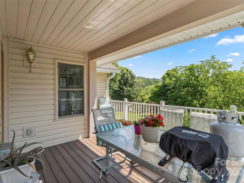 862 Asbury Road, Candler, NC 28715.  MLS# CAR4275719, YatesRealty ID 24339. Covered back porch / Trex deck