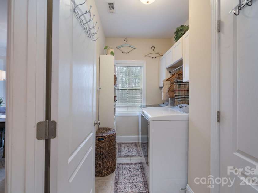 303 Ridge Reserve Drive, Clover, SC 29710.  MLS# CAR4232710, YatesRealty ID 24358. Roomy laundry with window and plenty of storage space and beautiful cabinetry.