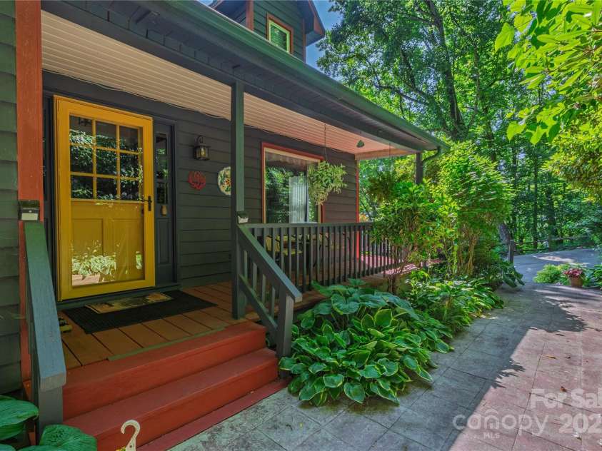 2981 Heath Peak Road, Waynesville, NC 28785.  MLS# CAR4266854, YatesRealty ID 24381. Main entrance door and rocking chair front porch