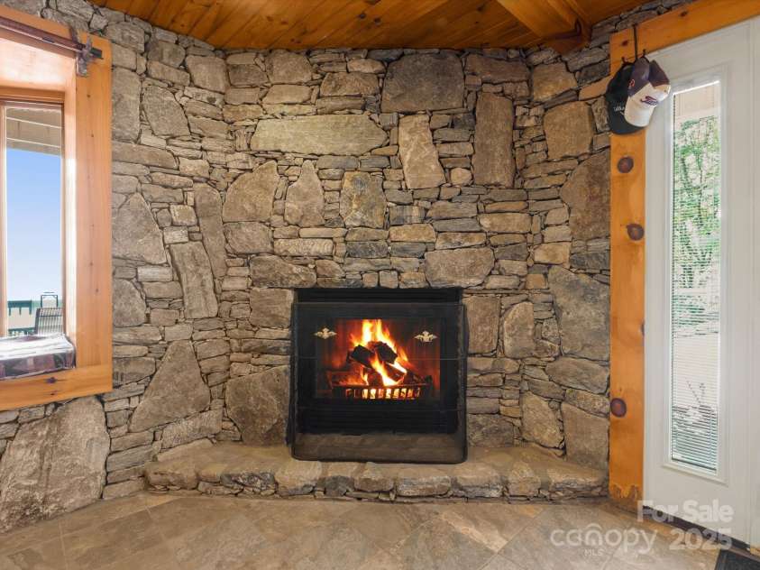 2981 Heath Peak Road, Waynesville, NC 28785.  MLS# CAR4266854, YatesRealty ID 24381. Stone fireplace in the basement