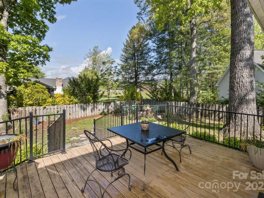 301 Theron Court, Candler, NC 28715.  MLS# CAR4250972, YatesRealty ID 24385. Nice sized deck for entertaining just off the screened porch