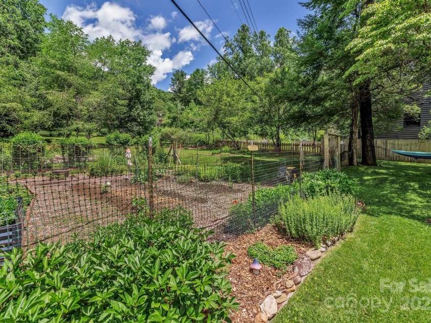 111 Assembly Drive, Montreat, NC 28757.  MLS# CAR4271152, YatesRealty ID 24388. A huge fenced in garden with 5 years of compost added yearly as well as a 2 feet trench dug around it, chicken wire put in and mulched over to keep rodents out. The garden's perimeter is lined with daisies, black eyed su