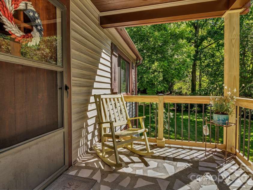 111 Assembly Drive, Montreat, NC 28757.  MLS# CAR4271152, YatesRealty ID 24388. Front porch facing Assembly Drive and across from Flat Creek.
