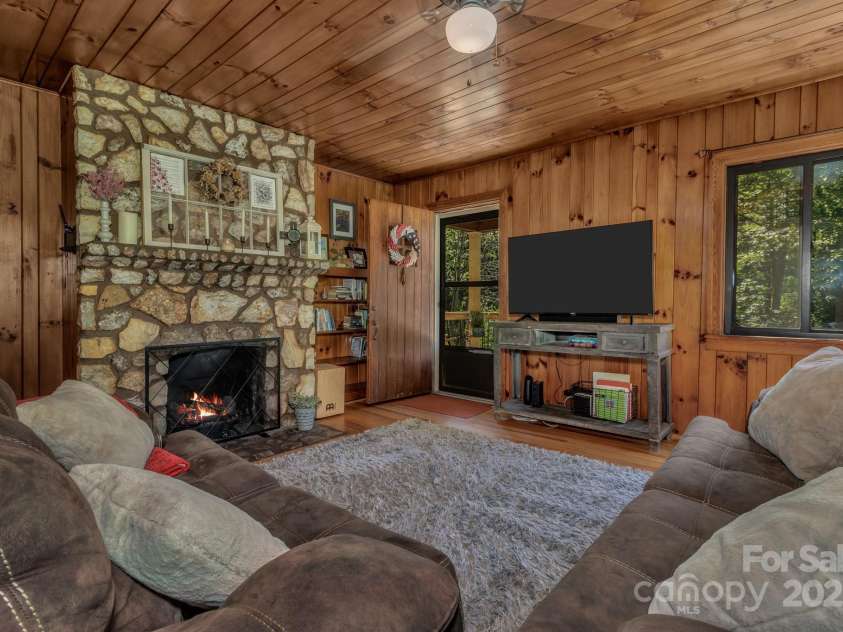 111 Assembly Drive, Montreat, NC 28757.  MLS# CAR4271152, YatesRealty ID 24388. Living Room with locally sourced stone for the fireplace and pine walls and ceilings.