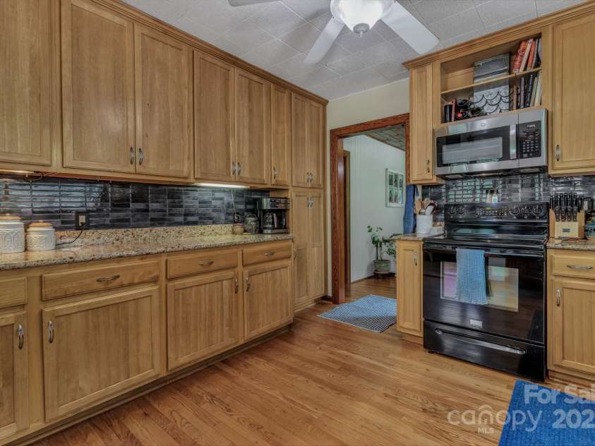 111 Assembly Drive, Montreat, NC 28757.  MLS# CAR4271152, YatesRealty ID 24388. Spacious kitchen for cooking and entertaining at back door and next to mudroom or breakfast nook as well as laundry closet with solid wood accordion door.