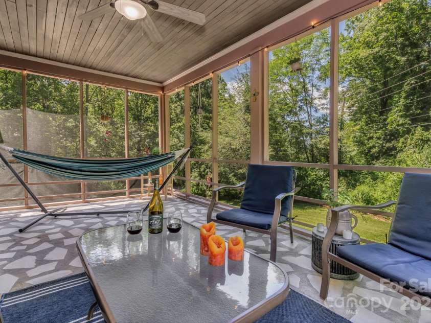 111 Assembly Drive, Montreat, NC 28757.  MLS# CAR4271152, YatesRealty ID 24388. Spacious screened in porch that was just pressure washed, painted, and rescreened. Throughout the day you can sit and hear birds chirping, leaves rustling and the creek across the street.