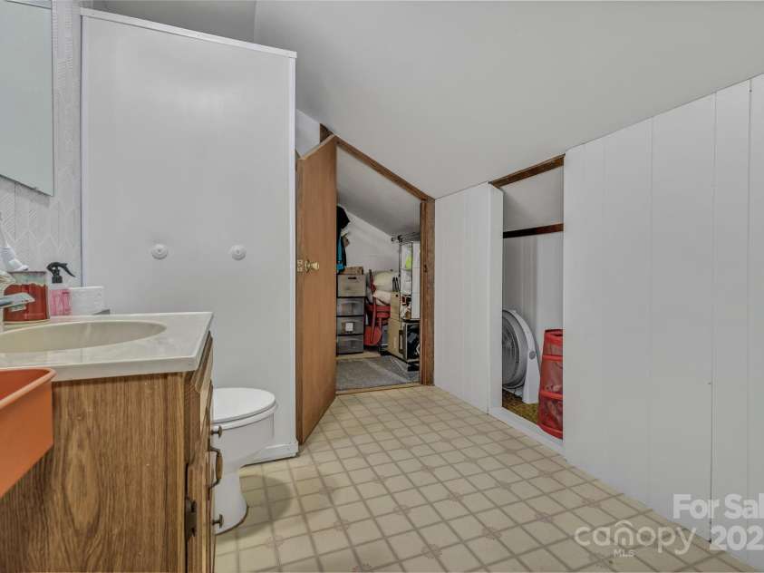 111 Assembly Drive, Montreat, NC 28757.  MLS# CAR4271152, YatesRealty ID 24388. Upstairs bathroom with storage behind wall and attic closet that extends entire length of bathroom.