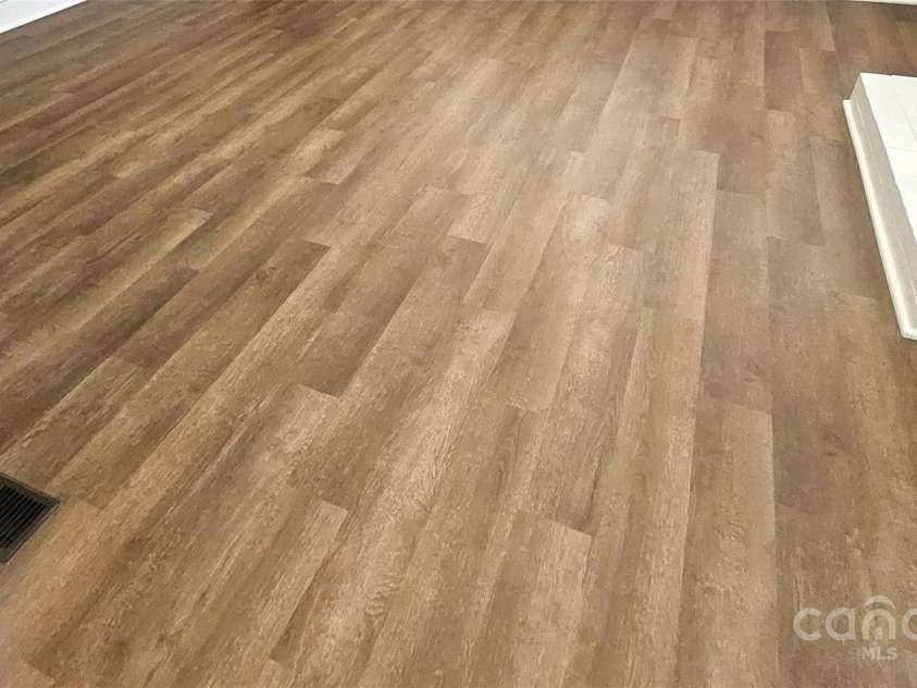 169 Freeze Avenue, Concord, NC 28025.  MLS# CAR4254472, YatesRealty ID 24392. New wood vinyl floors entire home. 