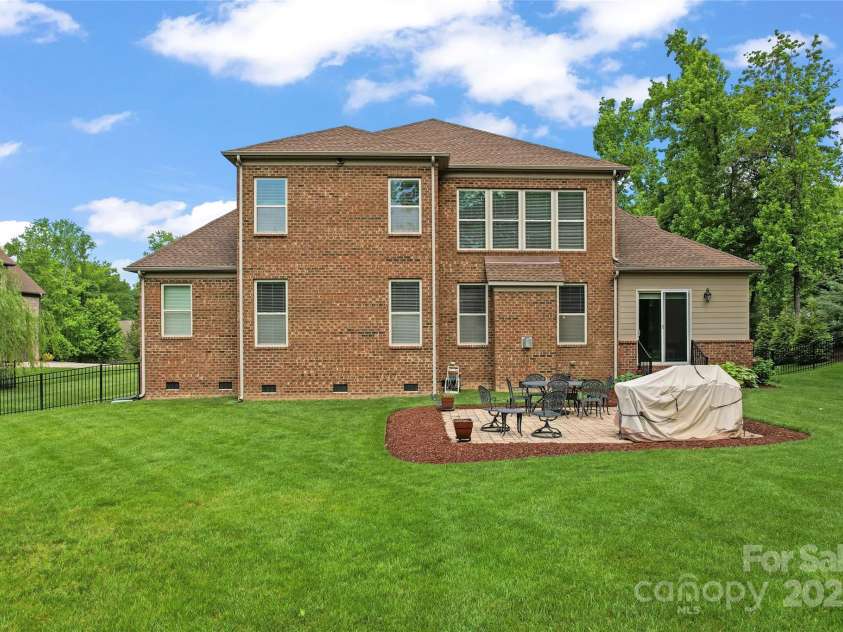 1400 Delaney Drive, Matthews, NC 28104.  MLS# CAR4255210, YatesRealty ID 24424. Back yard and rear of home