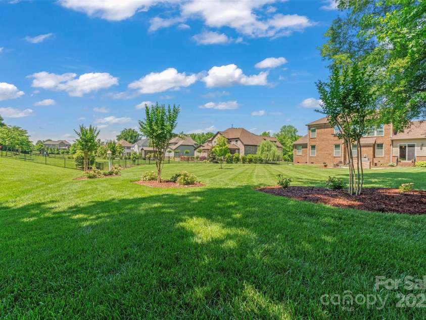 1400 Delaney Drive, Matthews, NC 28104.  MLS# CAR4255210, YatesRealty ID 24424. Back yard looking back at home