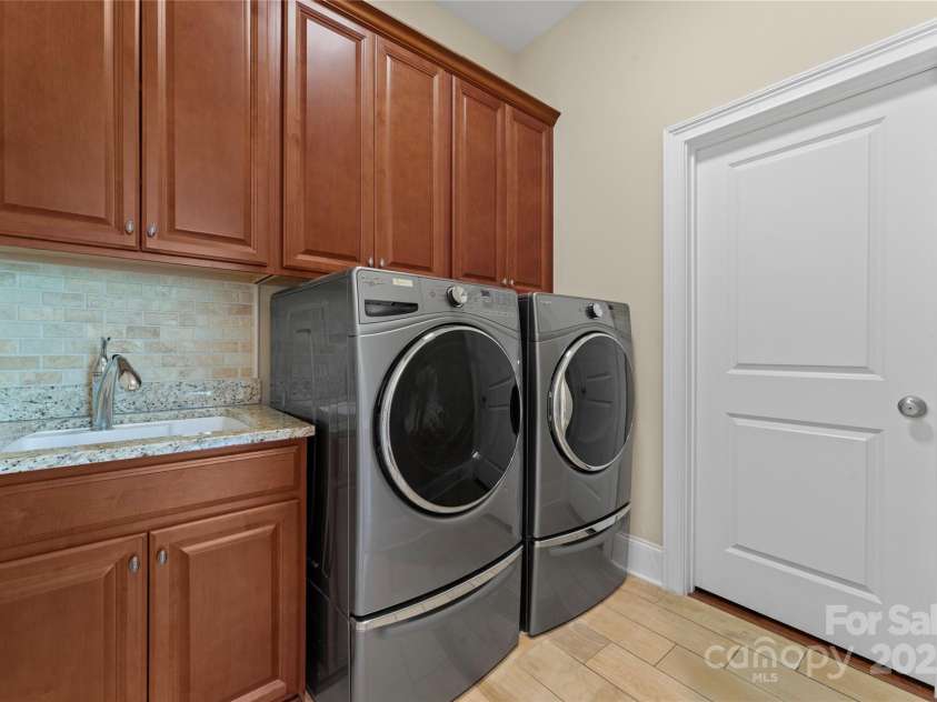 1400 Delaney Drive, Matthews, NC 28104.  MLS# CAR4255210, YatesRealty ID 24424. Main level laundry room