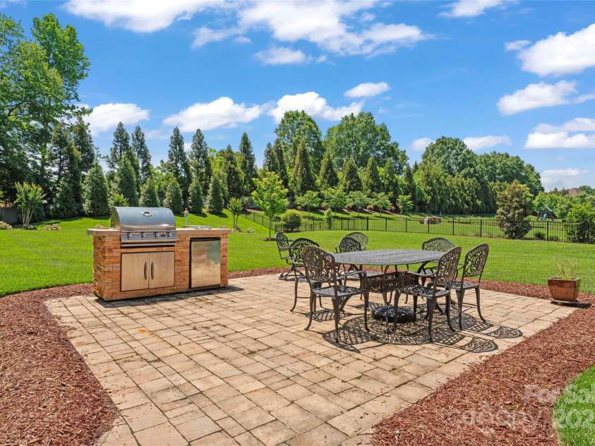 1400 Delaney Drive, Matthews, NC 28104.  MLS# CAR4255210, YatesRealty ID 24424. Pato w/built-in gas grill and mini fridge