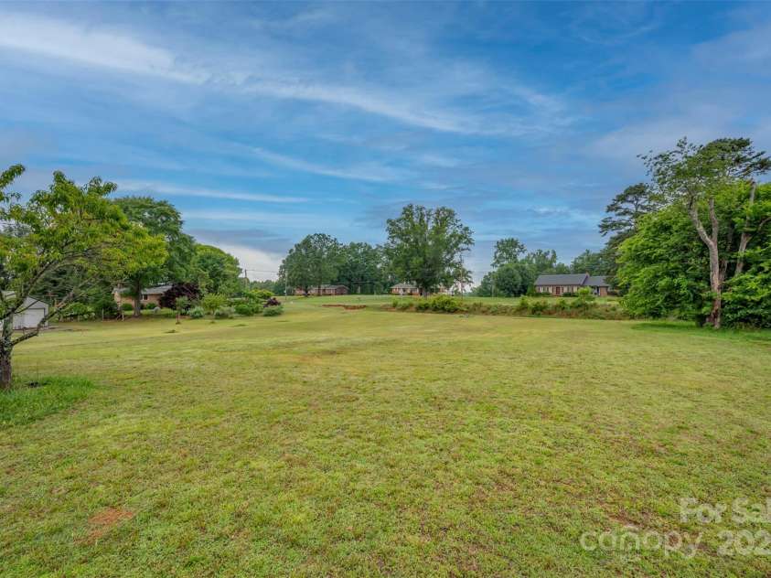 1761 Oak Grove Church Road, Ellenboro, NC 28040.  MLS# CAR4259419, YatesRealty ID 24431. Rear extra lot facing Beams Mill Rd with shared well (2 neighbors across street) and fruit trees