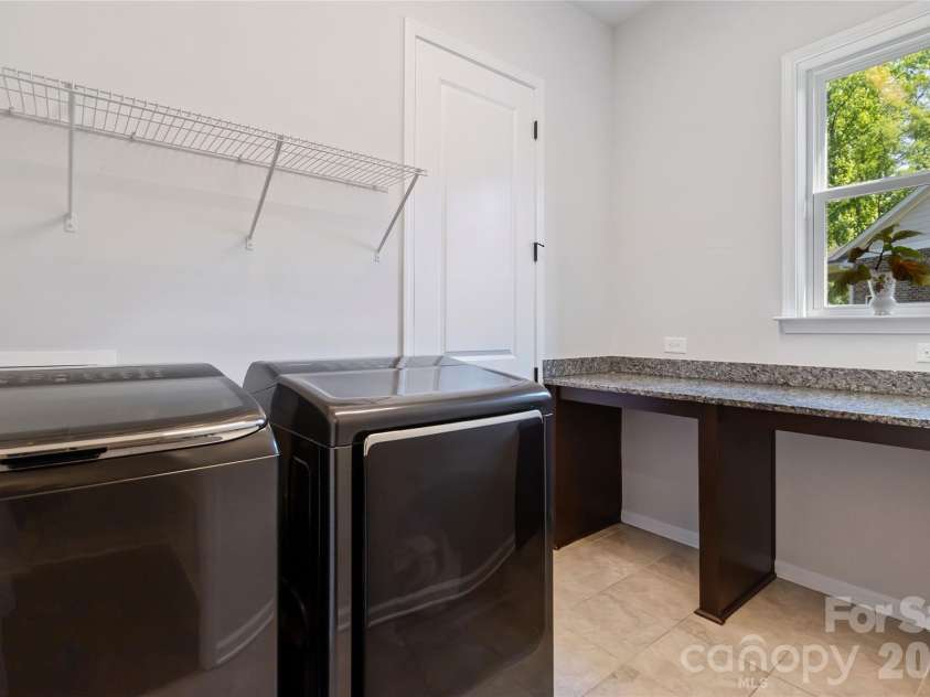 1124 Greenbridge Drive, Matthews, NC 28105.  MLS# CAR4373160, YatesRealty ID 24433. Laundry room with counter space!