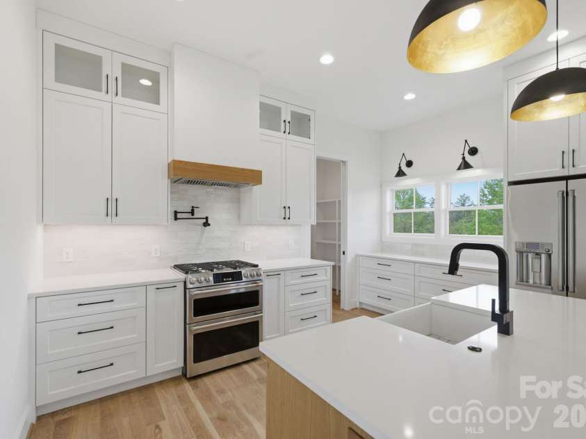 244 Westridge Farm Road, Asheville, NC 28804.  MLS# CAR4371030, YatesRealty ID 24441. Chef's kitchen feat. double oven, gas range, & pot-filler