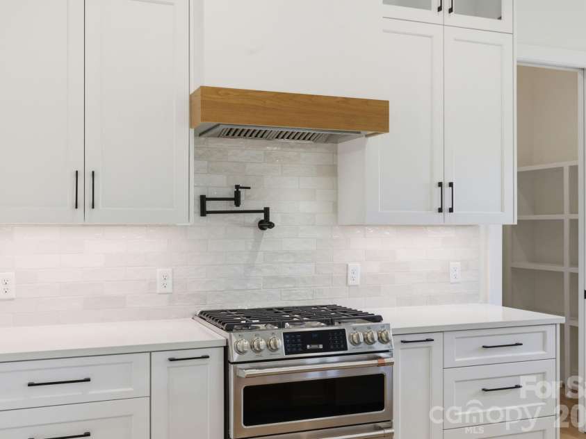 244 Westridge Farm Road, Asheville, NC 28804.  MLS# CAR4371030, YatesRealty ID 24441. Chef's kitchen feat. double oven, gas range, & pot-filler