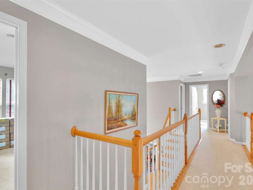 10837 Wilklee Drive, Charlotte, NC 28277.  MLS# CAR4291403, YatesRealty ID 2445. Upstairs hallway/catwalk opens down to foyer with dual staircase on one side and family room on the other side