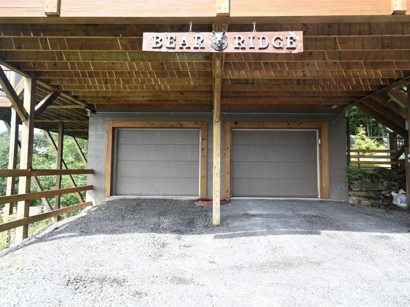 211 Sky Drive, Maggie Valley, NC 28751.  MLS# CAR4276346, YatesRealty ID 24456. Double garage doors into the basement with garage door openers