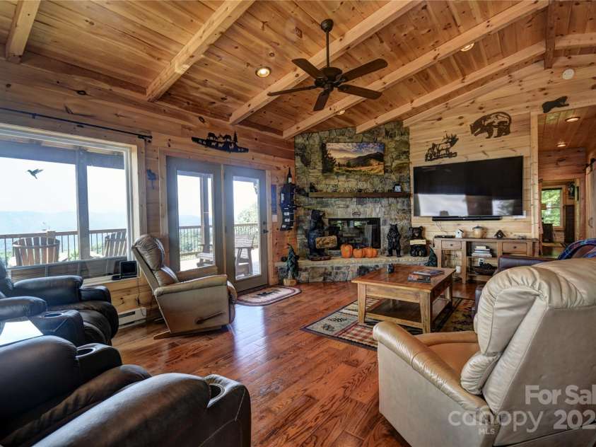 211 Sky Drive, Maggie Valley, NC 28751.  MLS# CAR4276346, YatesRealty ID 24456. Great Room from the entry door (wood-burning fireplace)