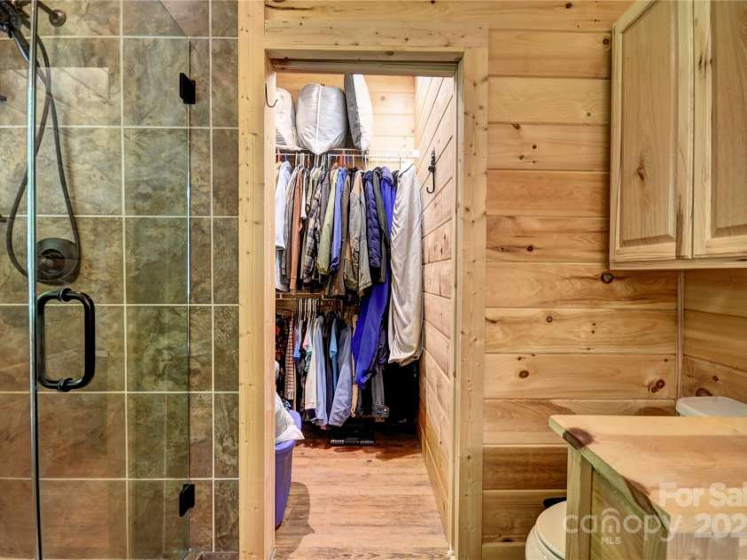 211 Sky Drive, Maggie Valley, NC 28751.  MLS# CAR4276346, YatesRealty ID 24456. The primary bath leads into a walk-in closet