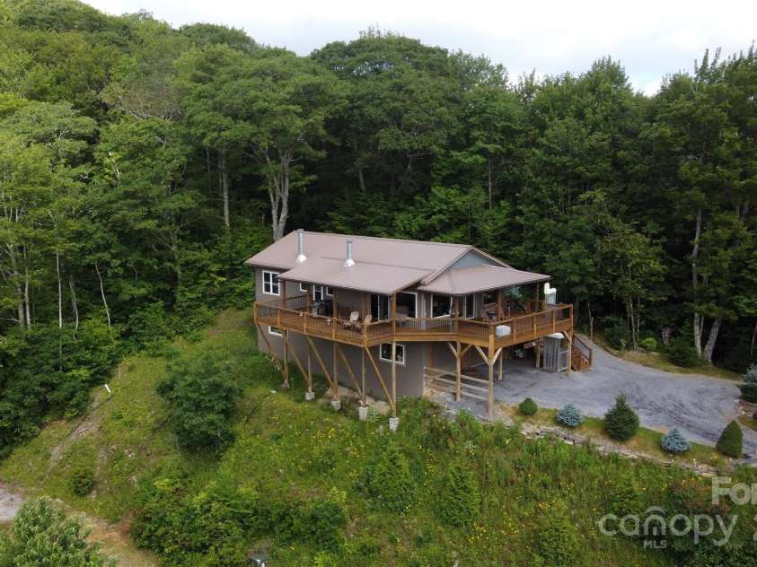 211 Sky Drive, Maggie Valley, NC 28751.  MLS# CAR4276346, YatesRealty ID 24456. Top of the ridge home from a drone