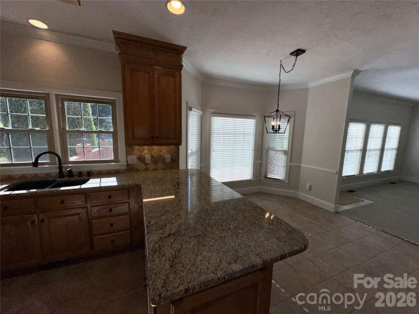 8219 Deer Drive, Harrisburg, NC 28075.  MLS# CAR4372897, YatesRealty ID 24458. Kitchen open to Breakfast area & Den + FP