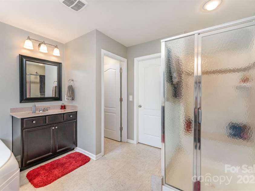133 Glade Valley Avenue, Mooresville, NC 28117.  MLS# CAR4275294, YatesRealty ID 24460. Primary bath with shower, separate vanities