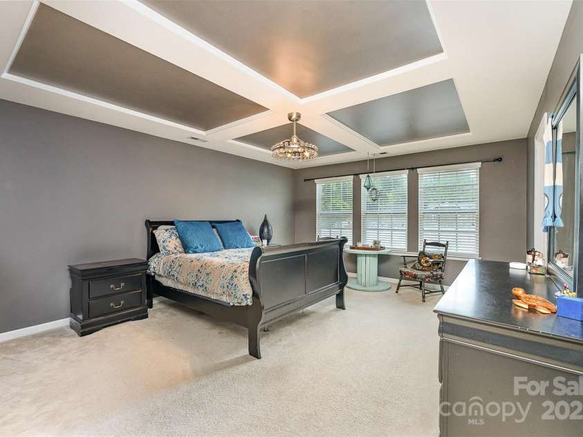 133 Glade Valley Avenue, Mooresville, NC 28117.  MLS# CAR4275294, YatesRealty ID 24460. Primary bedroom with coffered ceilings