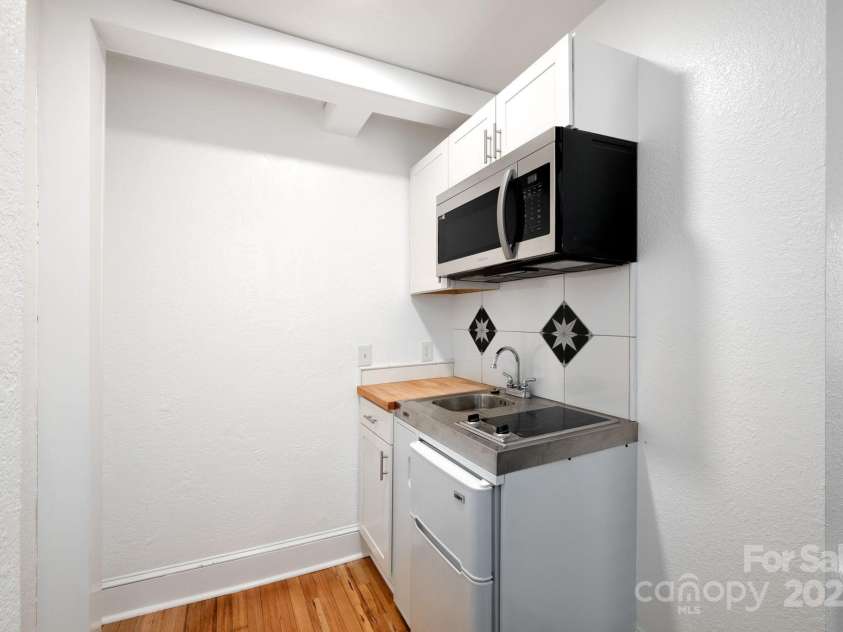 100 West Street, Asheville, NC 28801.  MLS# CAR4252473, YatesRealty ID 24461. Kitchenette in guest/office suite