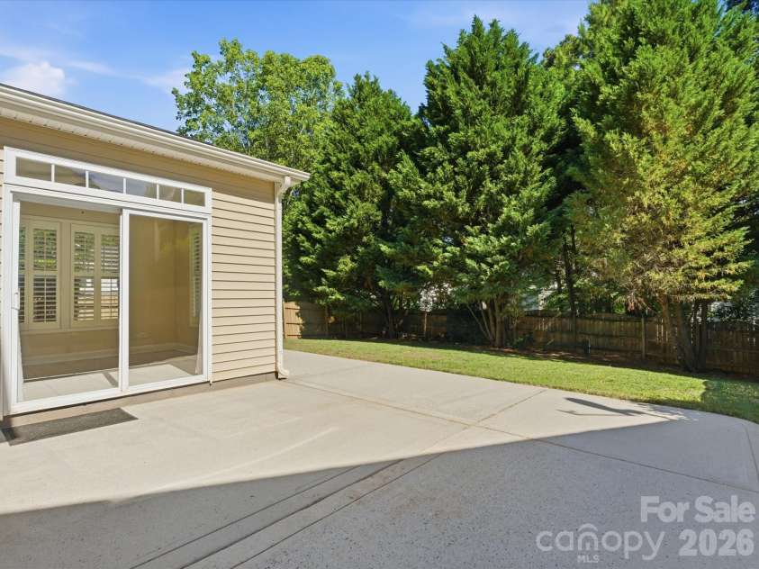 10094 Paisley Drive, Charlotte, NC 28269.  MLS# CAR4382557, YatesRealty ID 24509. Sunroom addition with oversized windows and sliding glass doors provides a bright transition between indoor and outdoor living spaces.