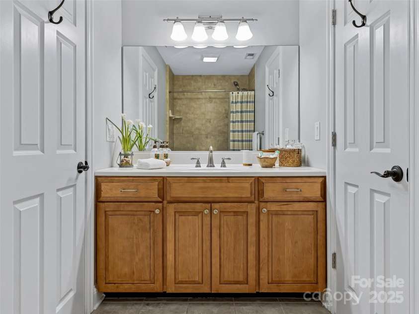 61 Mcintyre Drive, Asheville, NC 28803.  MLS# CAR4275405, YatesRealty ID 24516. Guest Bathroom with Wood Vanity