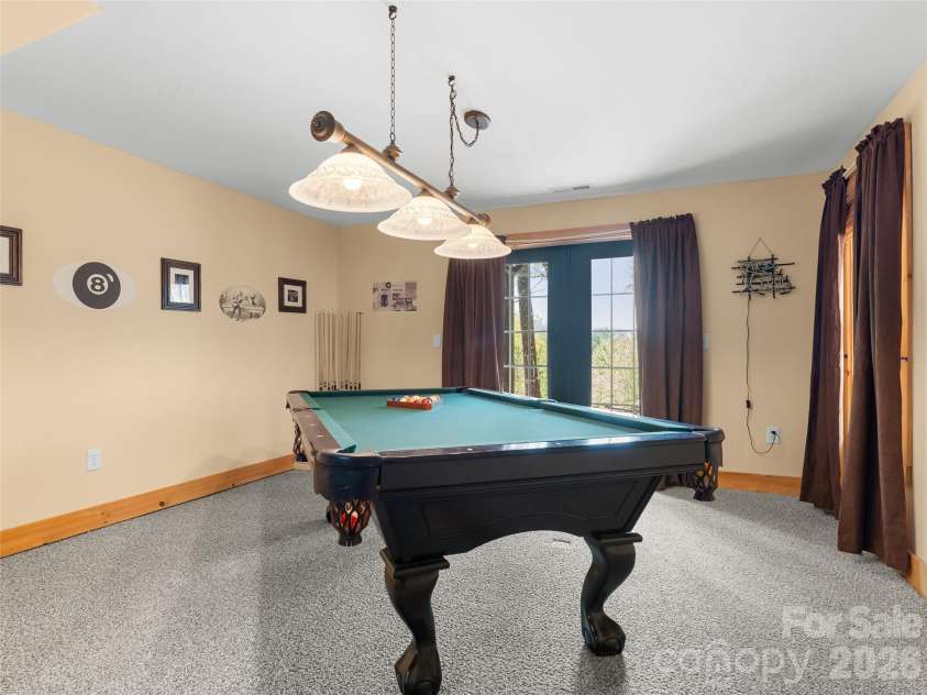 462 Deep Woods Lane, Saluda, NC 28773.  MLS# CAR4366925, YatesRealty ID 24522. Room for a pool table and doors to outside