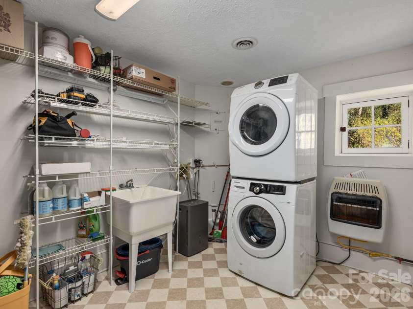 67 Cherokee Road, Asheville, NC 28801.  MLS# CAR4339931, YatesRealty ID 24525. Lower Level Laundry with Gracious Storage