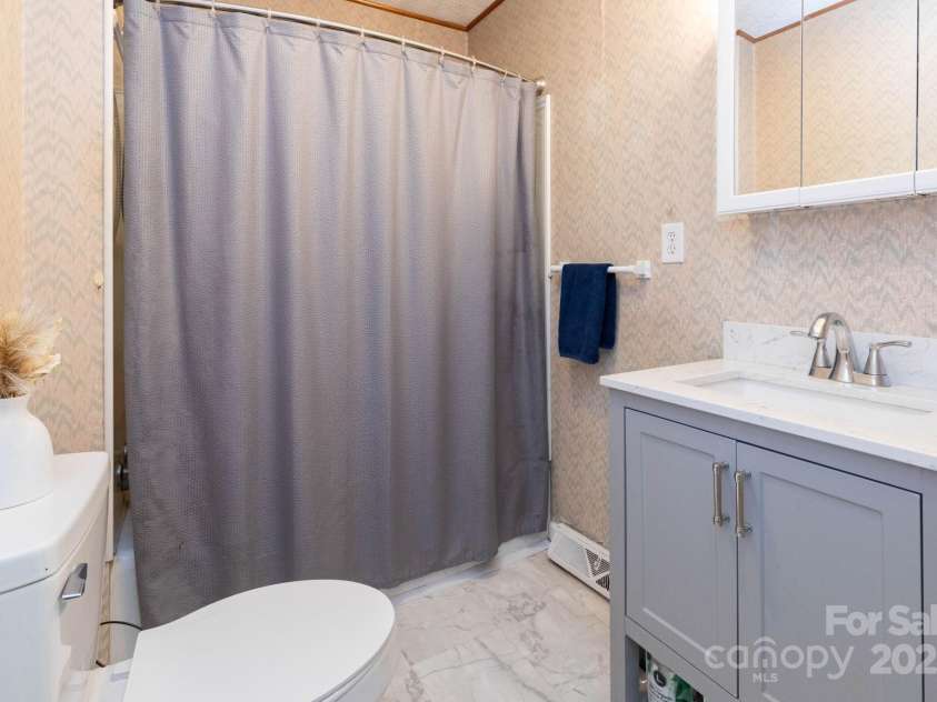15 Gaddy Road, Weaverville, NC 28787.  MLS# CAR4260731, YatesRealty ID 24529. 1st bathroom/guest bathroom located in between living and dining room