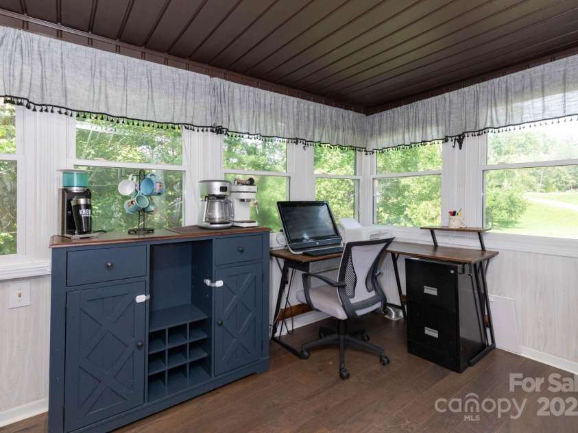 15 Gaddy Road, Weaverville, NC 28787.  MLS# CAR4260731, YatesRealty ID 24529. Sun room that leads to side deck and back screened porch