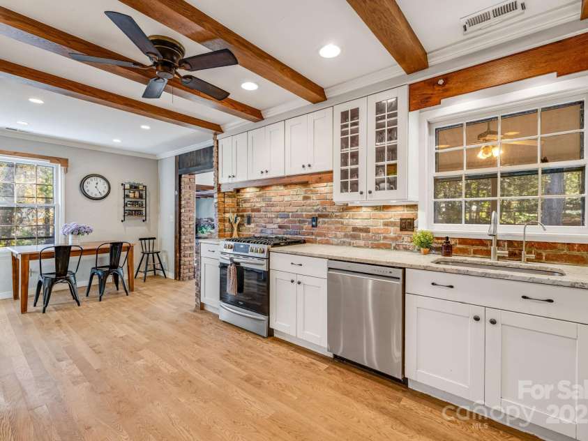 203 Davis Mountain Road, Laurel Park, NC 28739.  MLS# CAR4332728, YatesRealty ID 24540. Brick backsplash, shaker cabinetry, stainless steel appliances