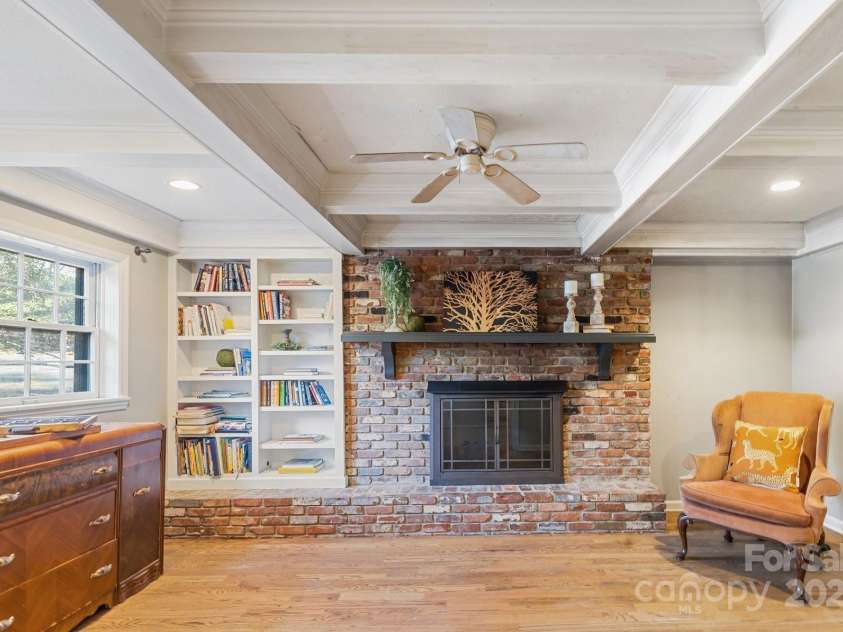 203 Davis Mountain Road, Laurel Park, NC 28739.  MLS# CAR4332728, YatesRealty ID 24540. Cozy den featuring coffered ceilings, gas fireplace, built-ins and hardwood floors