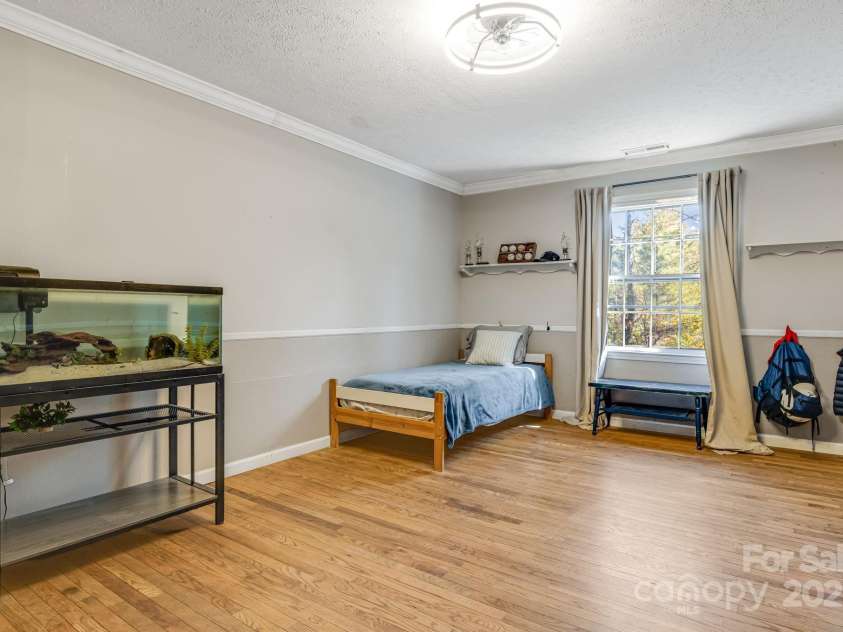 203 Davis Mountain Road, Laurel Park, NC 28739.  MLS# CAR4332728, YatesRealty ID 24540. Hardwood floors, neutral decor, large secondary bedroom 