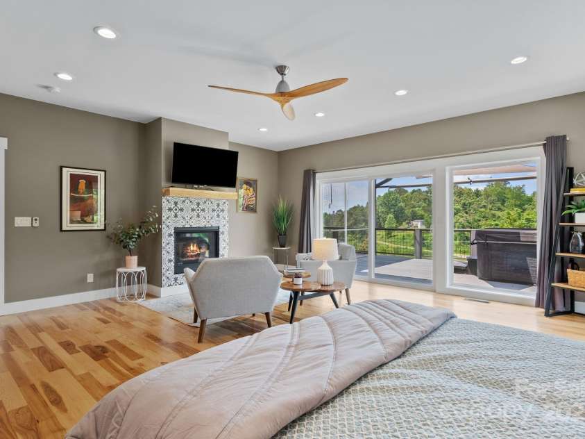 41 Bell Sprinkle Road, Weaverville, NC 28787.  MLS# CAR4268060, YatesRealty ID 24576. Primary bedroom fireplace