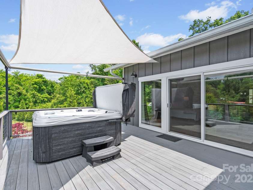 41 Bell Sprinkle Road, Weaverville, NC 28787.  MLS# CAR4268060, YatesRealty ID 24576. Relax in the hot tub on the primary bedroom deck!