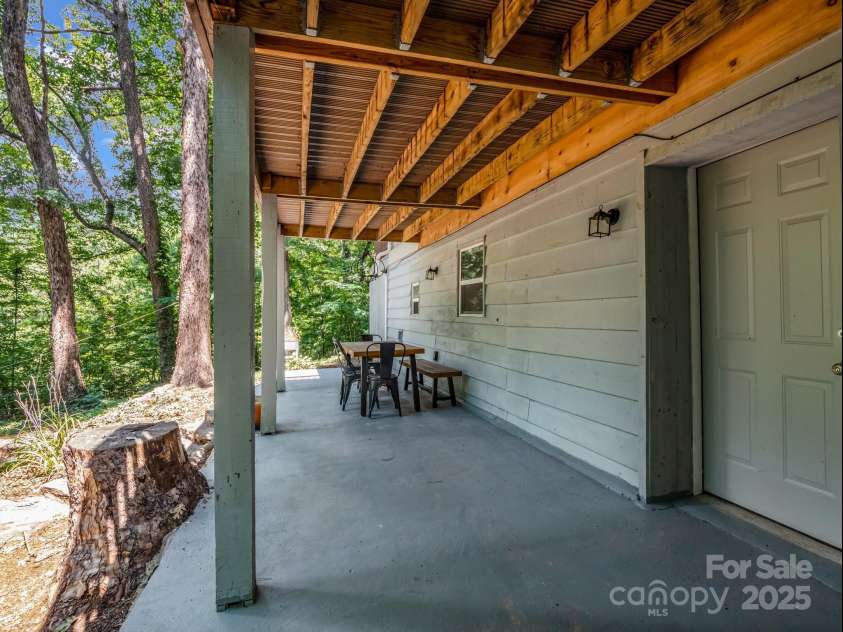 1463 Carolina Drive, Tryon, NC 28782.  MLS# CAR4275838, YatesRealty ID 24578. Back patio