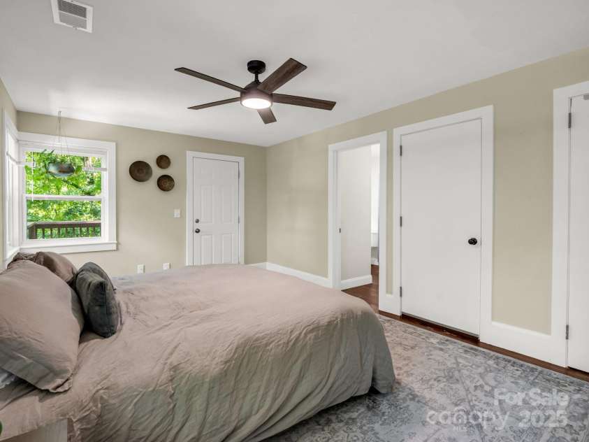 1463 Carolina Drive, Tryon, NC 28782.  MLS# CAR4275838, YatesRealty ID 24578. Door at the foot of the bed leads to a walk-up attic.  Door left of that is the bathroom.  The closet is the door on the right.