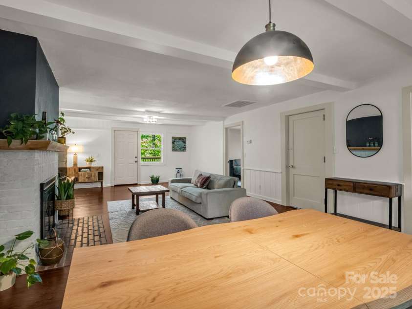 1463 Carolina Drive, Tryon, NC 28782.  MLS# CAR4275838, YatesRealty ID 24578. Door on the right leads to the basement, door on the left is to the primary bedroom and door straight ahead lads to the back deck