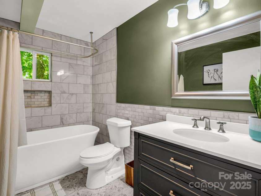 1463 Carolina Drive, Tryon, NC 28782.  MLS# CAR4275838, YatesRealty ID 24578. Guest bathroom on the main level